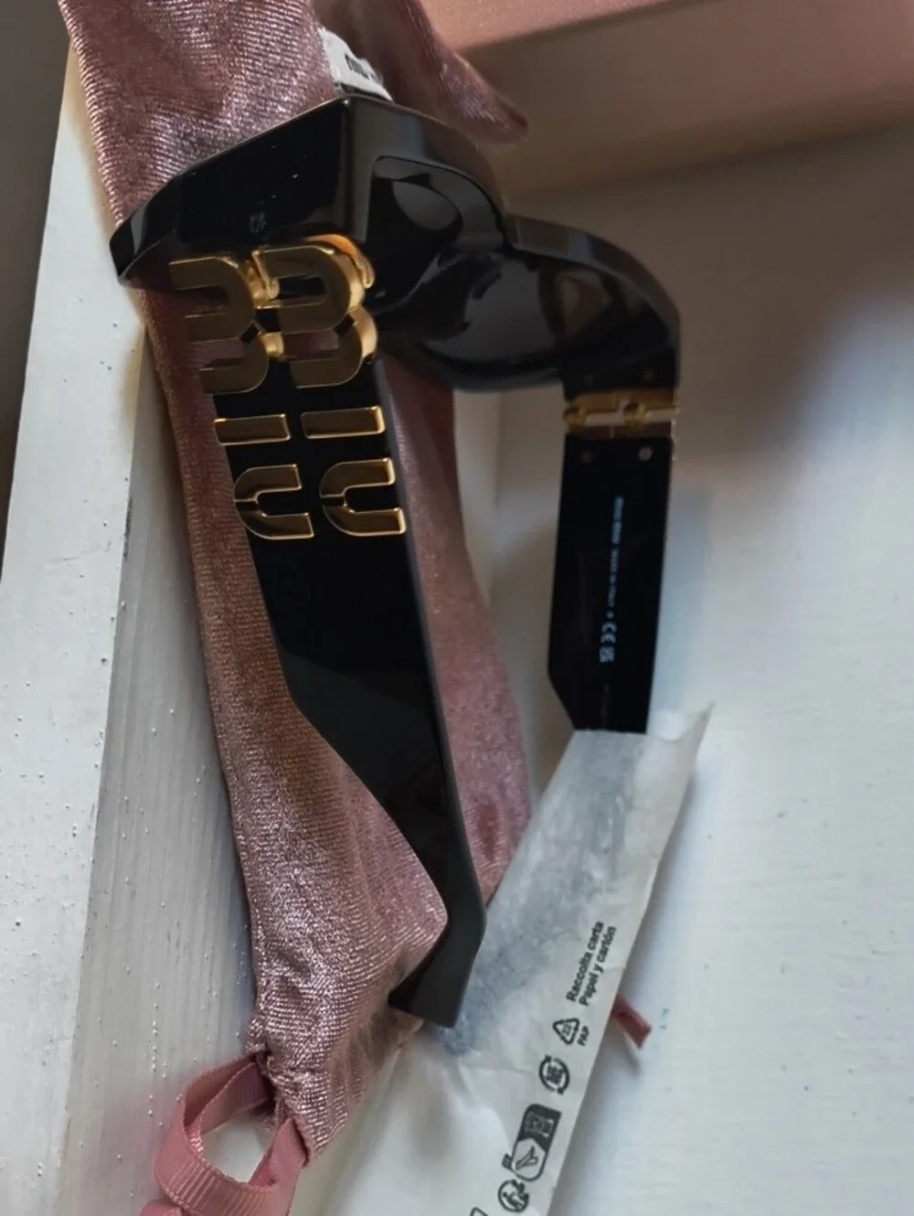 Miu Miu Black Sunglasses with Gold Logo Accent
